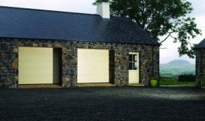 DuraTherm Insulated S-Ribbed Sectional Garage Doors custom painted, with a view of Slemish in the background.